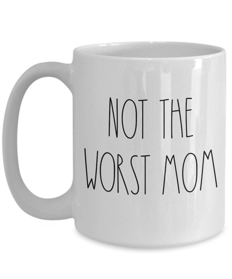 May include: White ceramic coffee mug with black text that reads "Not the worst mom".