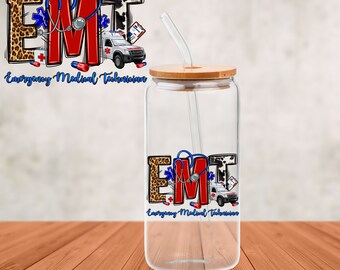 May include: A clear glass tumbler with a bamboo lid and a straw. The tumbler features the letters "EMT" in a design with a leopard print, red, and black and white cow print. The words "Emergency Medical Technician" are written below.