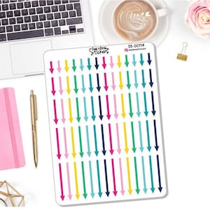 May include: A sheet of colorful arrow stickers with a white background. The arrows are in various colors, including pink, yellow, green, blue, and navy blue. The sheet is labeled "Daily Dose Stickers" and "DD-00714".