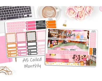 May include: A5 coiled monthly planner stickers with a Halloween theme. The stickers feature pink, black, and orange accents, with the word "October" in a decorative font. Includes stickers for each day of the week and decorative elements.