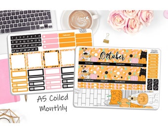 May include: Two Halloween-themed planner sticker sheets with orange, black, and pink accents. One sheet features a calendar layout with the text "A5 Coiled Monthly." The other sheet has an "October" header and decorative elements like pumpkins and black cats.
