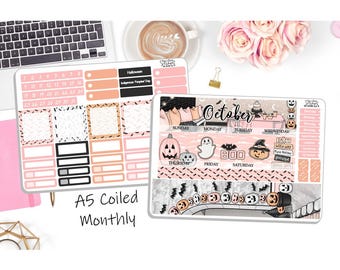May include: A pink and white Halloween themed monthly planner sticker sheet with a calendar, days of the week, and various Halloween themed icons. The sheet is labeled "October".