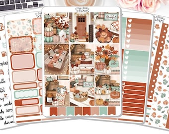 May include: Planner stickers with an autumnal theme. The stickers depict pumpkins, leaves, and the words "hello" and "Grateful". The colour scheme includes shades of orange, brown, and green.