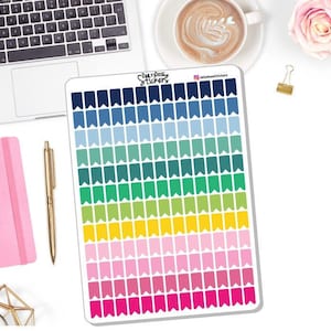 May include: A sheet of colorful flag stickers with a rainbow gradient of blue, green, yellow, pink, and red. The stickers are arranged in rows and columns on a white background. The text "Daily Dose Stickers" is printed in the top right corner.