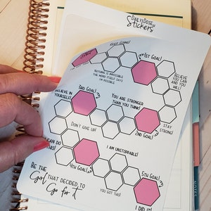 May include: A white sticker with a honeycomb design and pink motivational messages. The sticker says "Keep Going!" and "1st Goal!" at the top. The sticker also includes messages like "Believe in Yourself!" and "You Got This!"