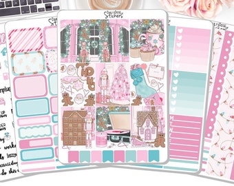 May include: A collection of planner stickers in pink, teal, and white, featuring Christmas-themed illustrations. Designs include gingerbread houses, nutcrackers, and Christmas trees. The stickers have text such as "hello" and "day off".