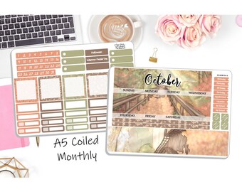 May include: A printable A5 monthly planner with a fall theme. The planner features a watercolor illustration of a bridge over a path with autumn leaves. The calendar includes boxes for each day of the month, as well as space for notes and appointments. The planner also includes a section for birthdays, holidays, and other important dates.