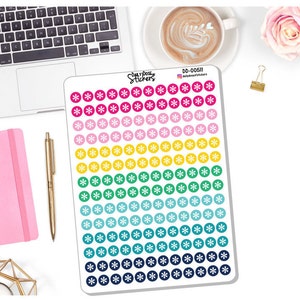 May include: A sheet of colorful circle stickers with a snowflake design. The stickers are arranged in rows of pink, light pink, yellow, green, teal, and navy blue. The text "Daily Dose Stickers" is visible.