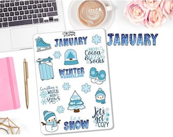 May include: A sheet of January themed planner stickers with blue, white, and black designs. The stickers feature winter-themed illustrations such as snowmen, snowflakes, a winter wonderland, and a snow globe. The text on the stickers includes "January", "Winter Wonderland", "Let it Snow", "Hot Cocoa & Fuzzy Socks", and "Everything is Magical When it Snows".