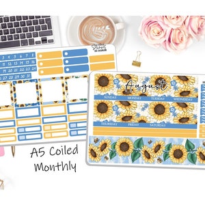 May include: An A5 coiled monthly planner featuring a sunflower and bee design. The planner includes a calendar grid with days of the week and a space for notes. The planner is decorated with sunflowers, bees, and blue flowers.
