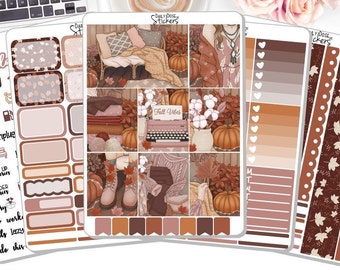 May include: A set of autumn-themed planner stickers with illustrations of pumpkins, leaves, and a typewriter. The stickers are in shades of brown, orange, and white. The text "Fall Vibes" is on one of the stickers.
