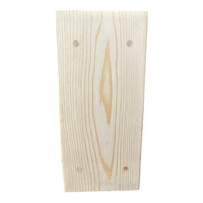 May include: A rectangular, unfinished wooden board with visible wood grain and four small, silver-colored fasteners. The board has a light, natural wood color and a slightly trapezoidal shape.