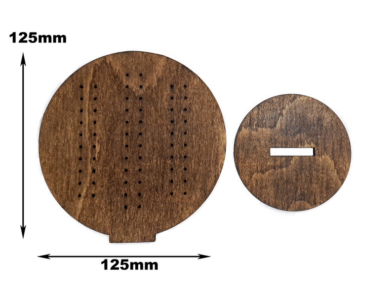 May include: A wooden game board with a circular playing surface and a separate circular base. The playing surface has a pattern of holes and the base has a slot cut out. The board measures 125 mm in diameter.