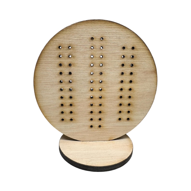 May include: A wooden peg board with three rows of holes, mounted on a round wooden base. The board is light brown and the holes are evenly spaced.