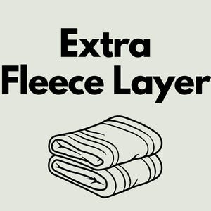 May include: A black and white illustration of a folded fleece blanket. The text "Extra Fleece Layer" is above the blanket.