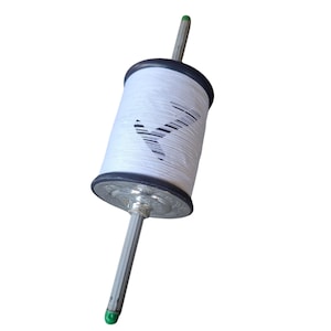 May include: A white kite string spool with a black and silver design. The spool has a black rim and a silver base. The string is white and has a black graphic. The handle is silver with a green tip.