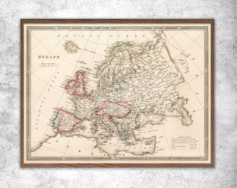 May include: An antique map of Europe from 1855, showing the countries and major cities of the continent. The map is printed in black, brown, red, and green ink on a cream-colored background. The map is framed in a brown wooden frame.