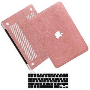 May include: Rose gold glitter laptop case with a matching keyboard. The case has the Apple logo and ventilation slots. The keyboard is black with white keys.