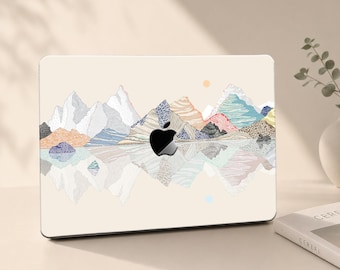 May include: A laptop skin featuring a cream-colored background with a stylized mountain range illustration. The mountains are rendered in various textures and pastel colors, including blue, orange, and white, with a reflection effect below.