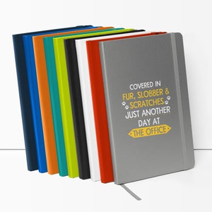 a stack of colored notebooks sitting on top of each other