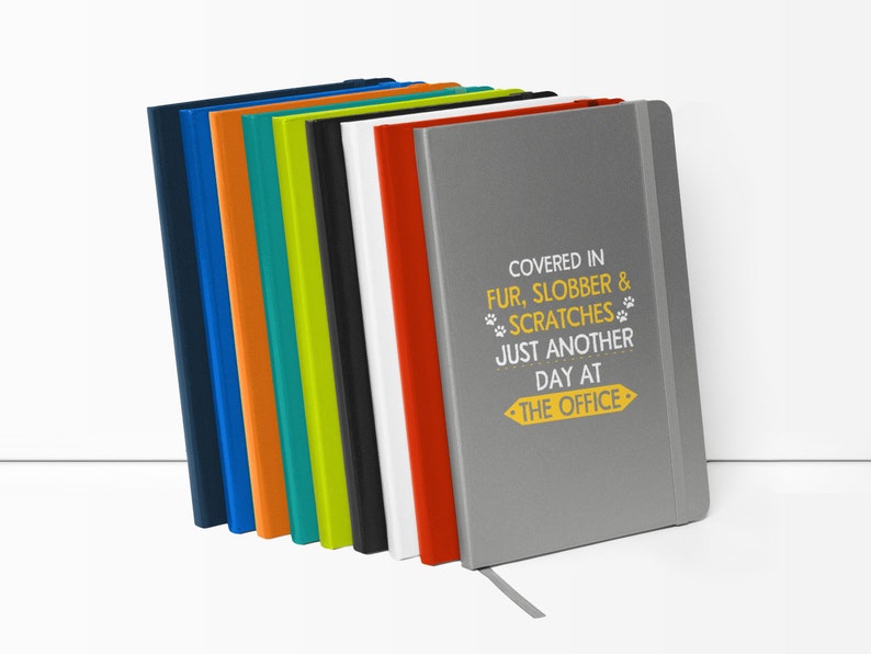 a stack of colored notebooks sitting on top of each other