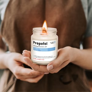 a person holding a candle in their hands