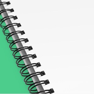 a spiral notebook with a green background