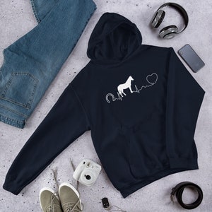 May include: A navy blue hoodie featuring a white horse silhouette, horseshoe, and heartbeat graphic. The graphic also includes a white heart.