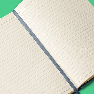 an open notebook on a green background
