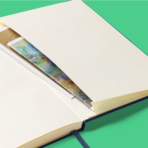 an open book with a pen sticking out of it