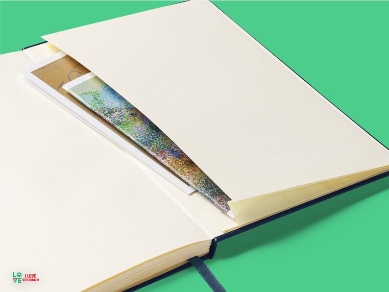 an open book with a pen sticking out of it