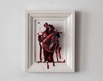 Anatomical human heart in a frame