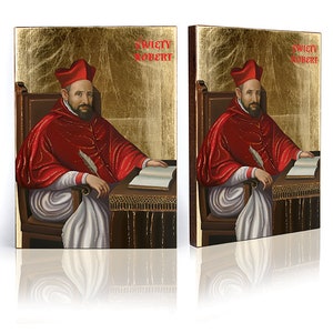 May include: Two framed paintings of a man in a red robe and a white hat, sitting in a chair with a book and a quill pen. The paintings are on a gold background with the text "Swiety Robert" at the top.