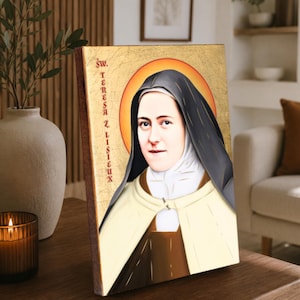May include: A rectangular wooden plaque featuring a portrait of Saint Teresa of Lisieux against a gold leaf background. The figure wears a black and white habit with a brown scapular. The text "ŚW. TERESA Z LISIEUX" is printed vertically in red.