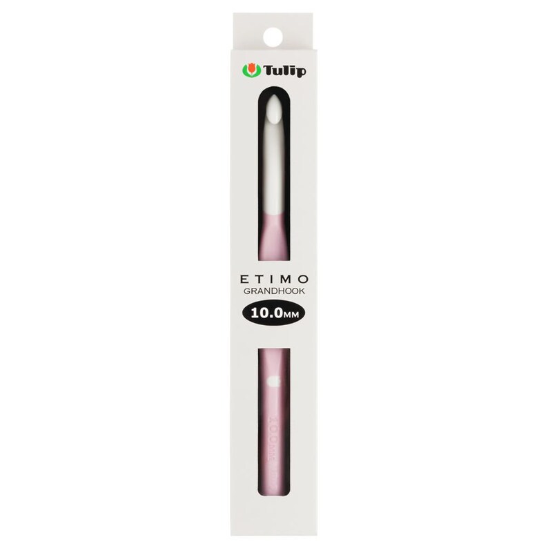 May include: A Tulip Etimo Grandhook crochet hook in a white retail box. The hook features a white tip and a light pink handle. The packaging displays the text Tulip, Etimo Grandhook, and 10.0mm in a black oval. The hook is 10.0mm in size.
