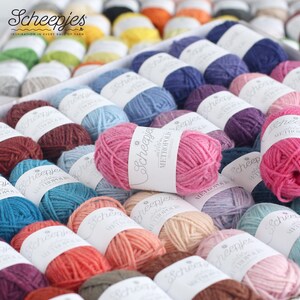May include: A variety of colorful yarn balls in a white box. The yarn is labeled "Scheepjes Metropolis" and is available in a wide range of colors.