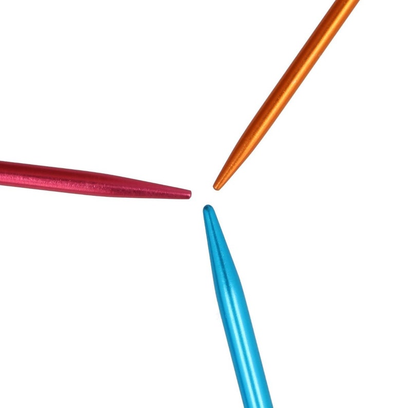 May include: Three knitting needles with pointed tips. The needles are made of metal and are colored orange, pink, and blue.