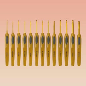 May include: A set of twelve crochet hooks with gold-colored metal tips and yellow handles. Each handle has a black oval grip and is labeled with a size in millimeters, ranging from 2.0 mm to 6.0 mm.