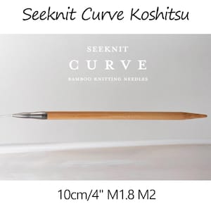 May include: A close-up of a 4-inch bamboo knitting needle with a metal tip. The needle is labeled "Seeknit Curve Bamboo Knitting Needles" and "10cm/4" M1.8 M2".