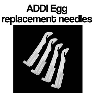 May include: Four white plastic replacement needles for an Addi Egg knitting machine.