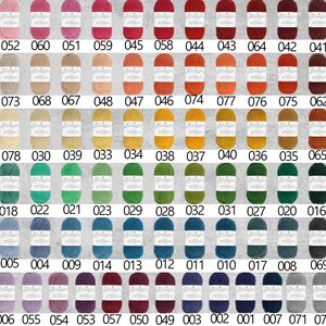 May include: A chart of 80 different colored yarn skeins, each labeled with a number. The yarn is arranged in rows of 13, with the numbers 061, 052, 060, 051, 059, 045, 058, 044, 043, 064, 042, 041, and 080 in the top row.