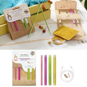 May include: A set of interchangeable knitting needles in a variety of colors, including pink, green, and gold. The needles are packaged in a brown burlap pouch with a giraffe logo and the text "Color soul beauty with Pony".