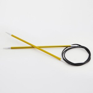 May include: A pair of yellow circular knitting needles with white tips and a black flexible cable. The needles are made of metal and are designed for knitting projects. The needles are shown against a white background.