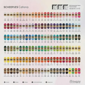 May include: A color chart of Scheepjes Catona 100% mercerized cotton fingering weight yarn. The chart displays a wide array of colors, including various shades of pink, blue, green, yellow, orange, and brown. The brand name and yarn type are visible.