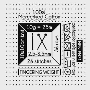 May include: A white label with black text and symbols, including "100% Mercerised Cotton" and "Fingering Weight." It also features knitting instructions: 10x10cm knit, 26 stitches, 36 rows, and needle size 2.5-3.5mm.