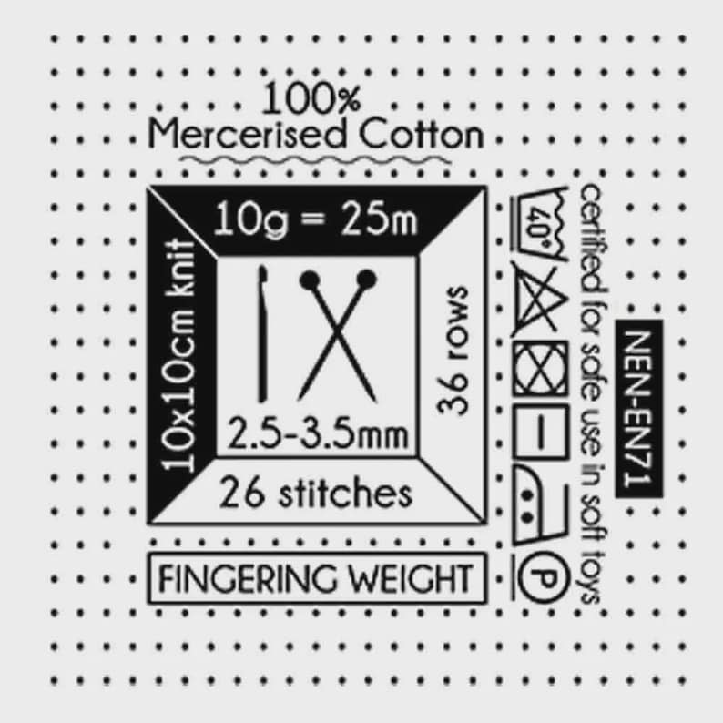 May include: A white label with black text and symbols, including "100% Mercerised Cotton" and "Fingering Weight." It also features knitting instructions: 10x10cm knit, 26 stitches, 36 rows, and needle size 2.5-3.5mm.