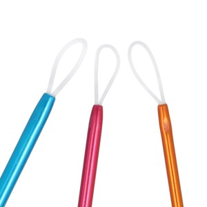 May include: Three crochet hooks with white loops at the top. The hooks are blue, pink, and orange.