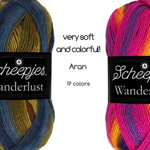 以下が含まれることがあります： 青、緑、茶色の糸と、ピンク、オレンジ、紫の糸の2つの糸巻き。両方の糸巻きには、「Scheepjes Wanderlust」と「Aran」のラベルと、帆船のロゴが貼られています。糸は「とても柔らかくカラフルです！」と説明されています。