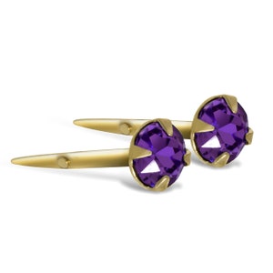 May include: A pair of gold stud earrings with purple gemstones. The earrings have a simple design and are perfect for everyday wear.