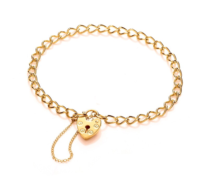May include: A gold chain bracelet with a heart-shaped padlock charm. The charm has a keyhole and a detailed design.
